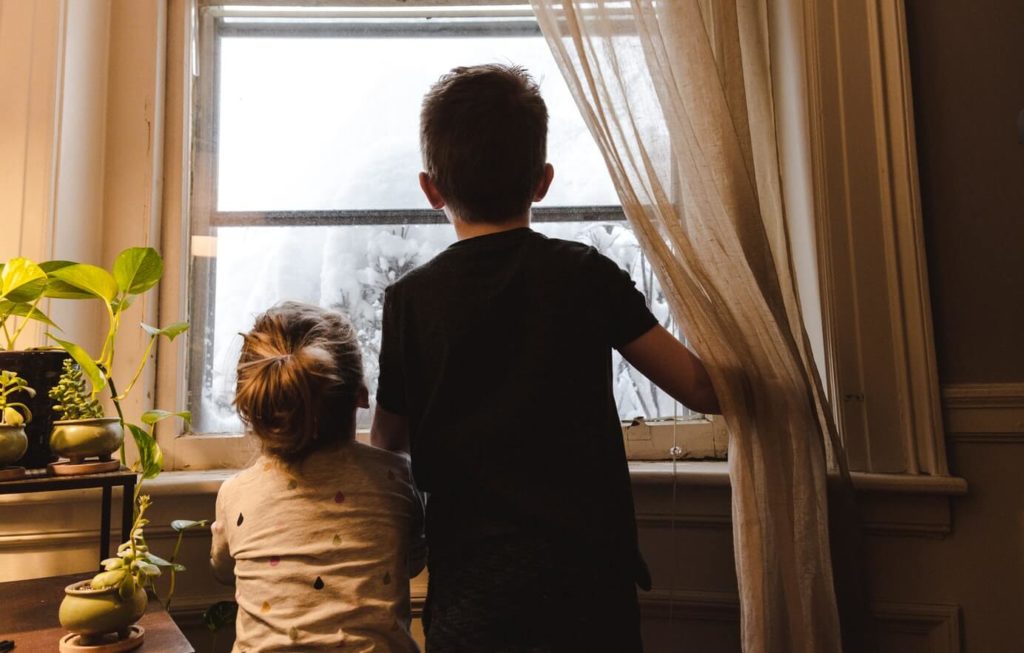 Two children looking out of the window of their home, the stability a Mesher order aims to protect