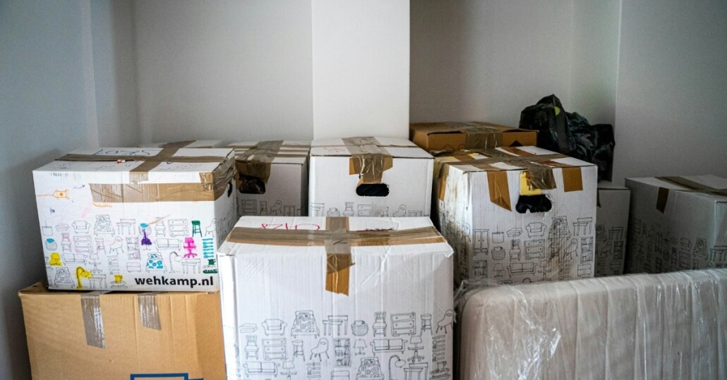 Packed moving boxes in an empty room, a common sight when working out who gets the house in a divorce
