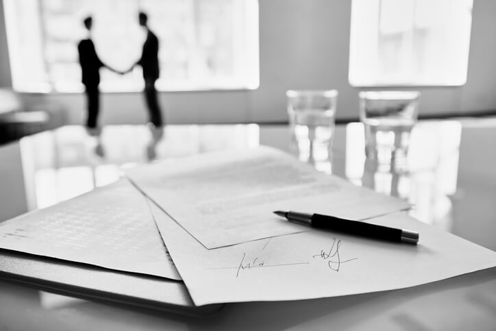 Interim care order papers: a parent reading court documents about their child at a kitchen table