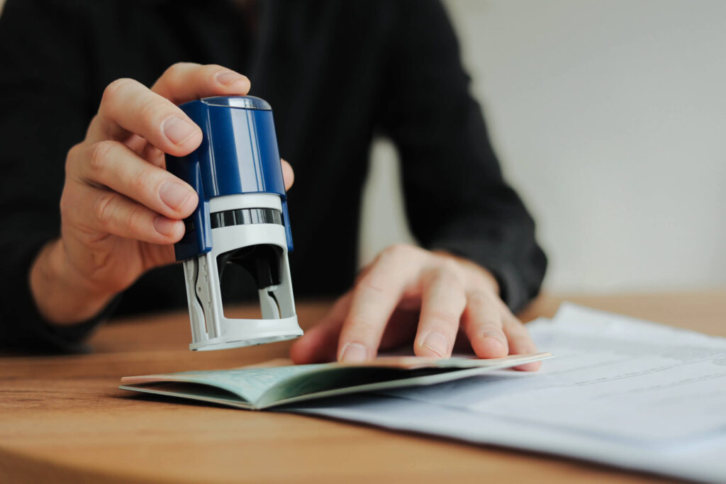 Civil restraint order: a hand lowering an office stamp onto paperwork on a desk