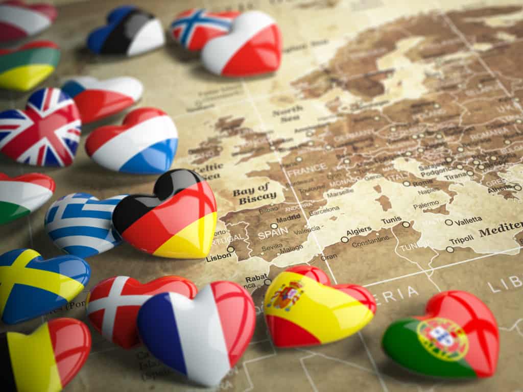 International divorce: heart-shaped national flags scattered across an old map of Europe